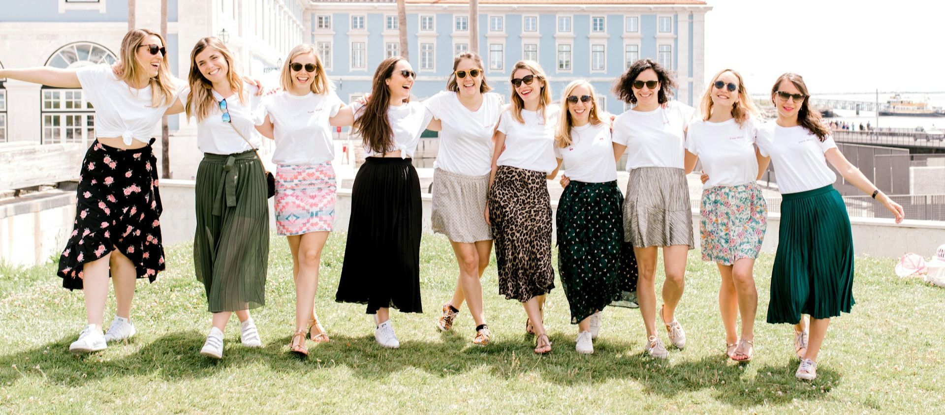 Group of friends walking together outdoors in coordinated outfits.