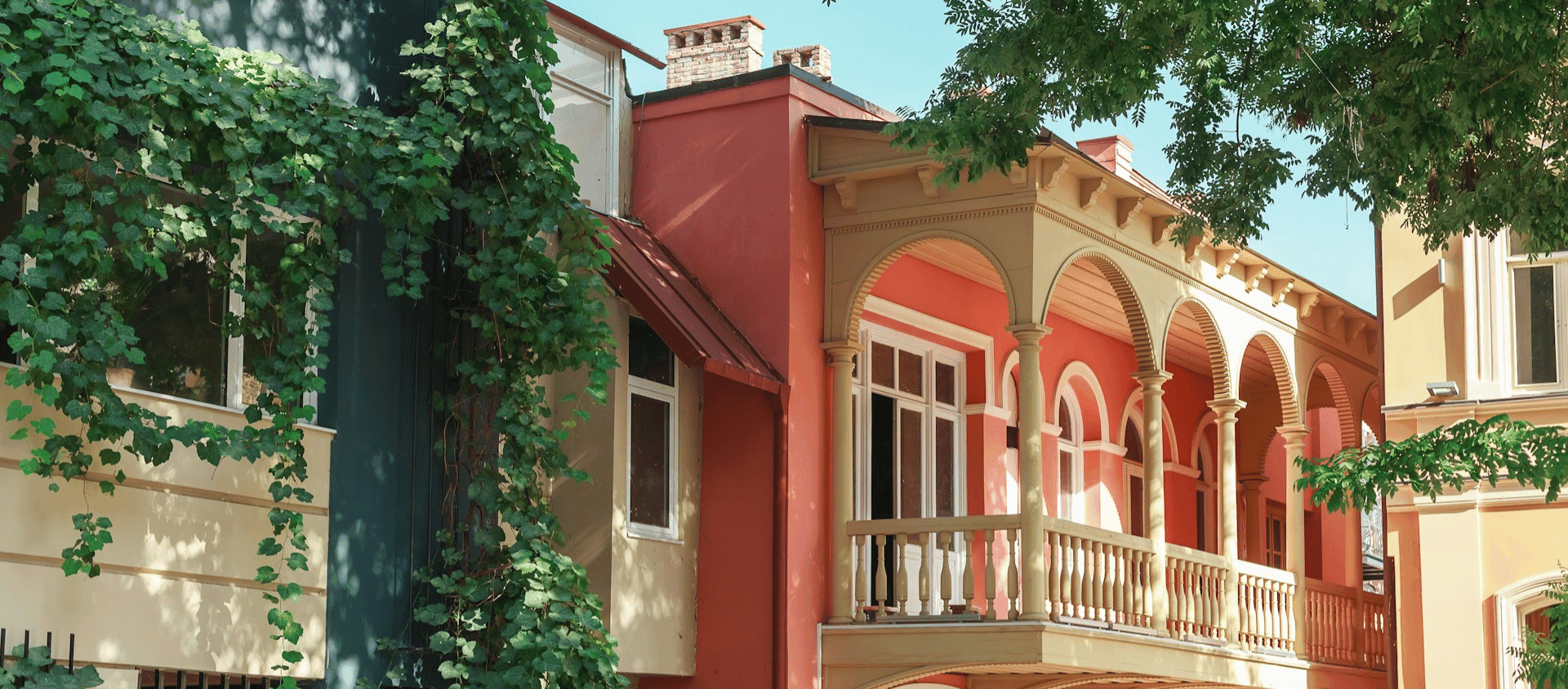 Colorful historic buildings with ivy-covered facades and arched windows in Charleston.