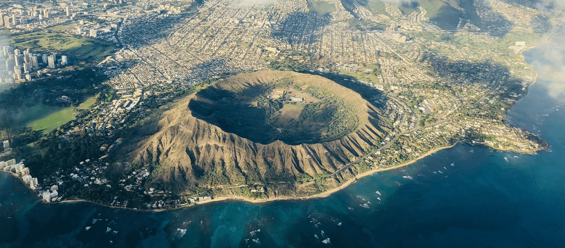An aerial view of Diamond Head Crater with a cloudy sky.