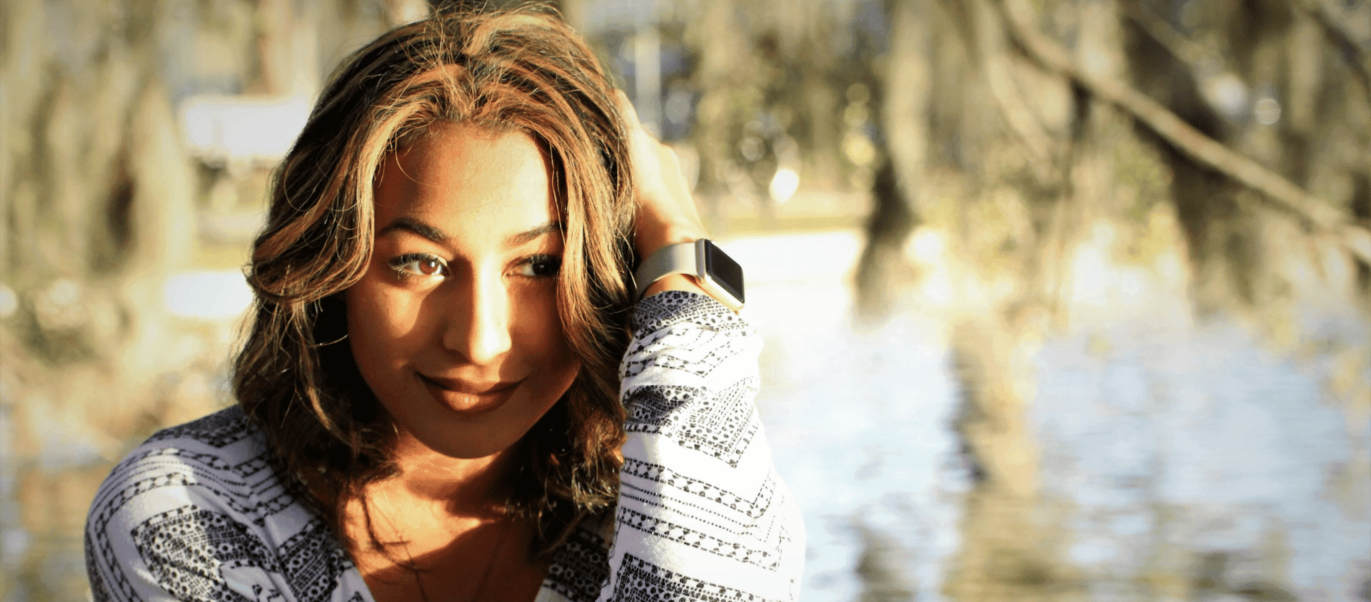 Woman posing outdoors in Savannah, Georgia surrounded by soft natural scenery.
