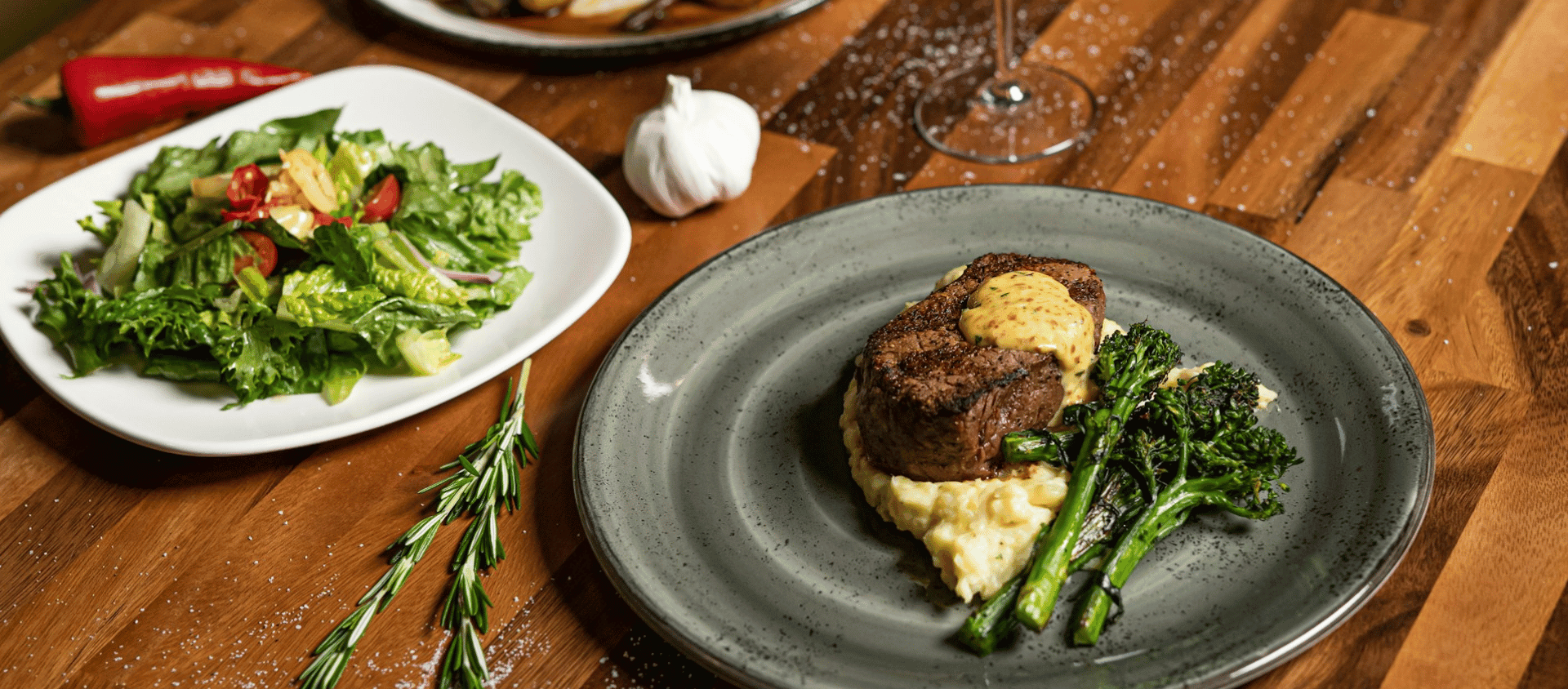 Pan seared filet mignon plated with vegetables.