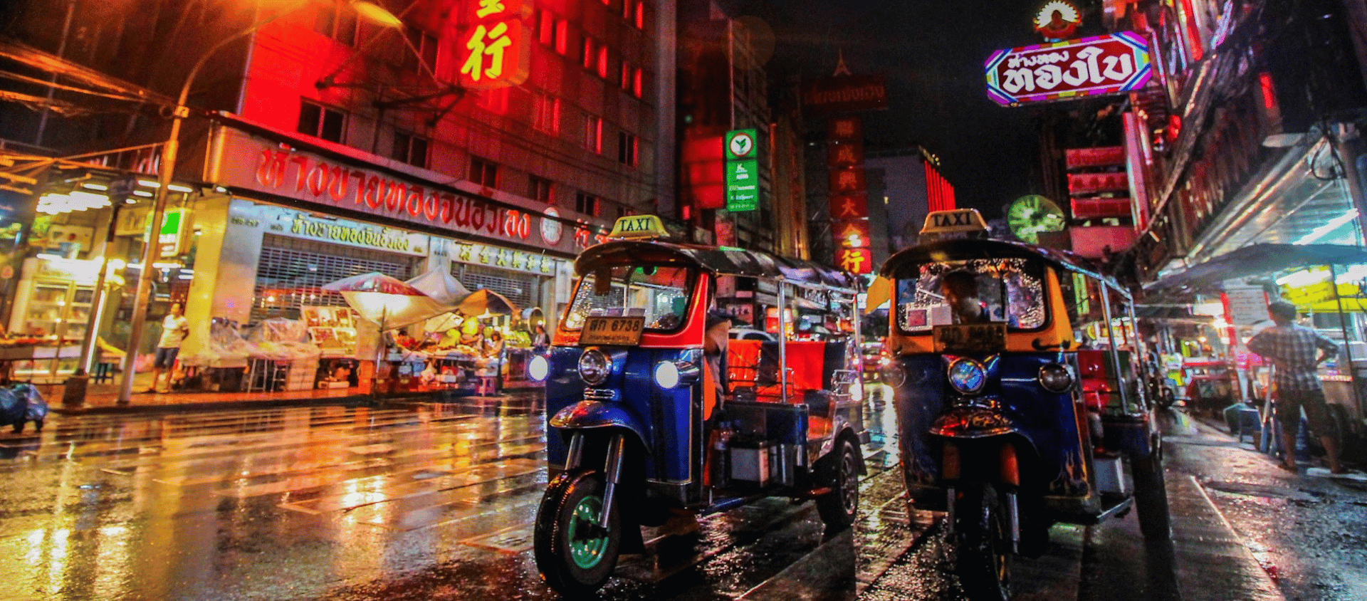 Tuk Tuks in Bangkok streets lit up at night