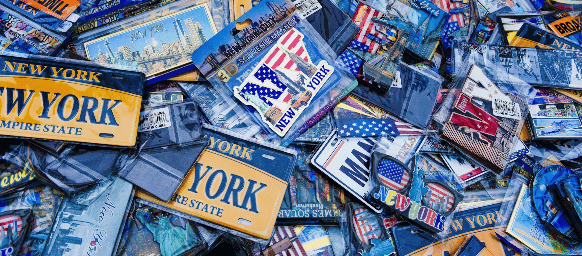 Assorted New York City souvenir magnets and license plate designs.