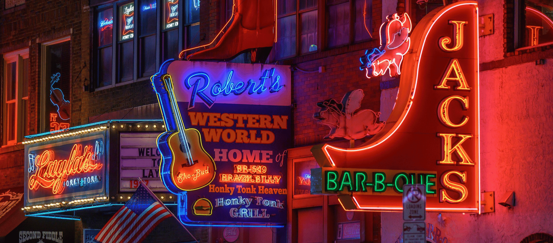 Colorful neon honky-tonk and bar signs lighting up Lower Broadway in Nashville.