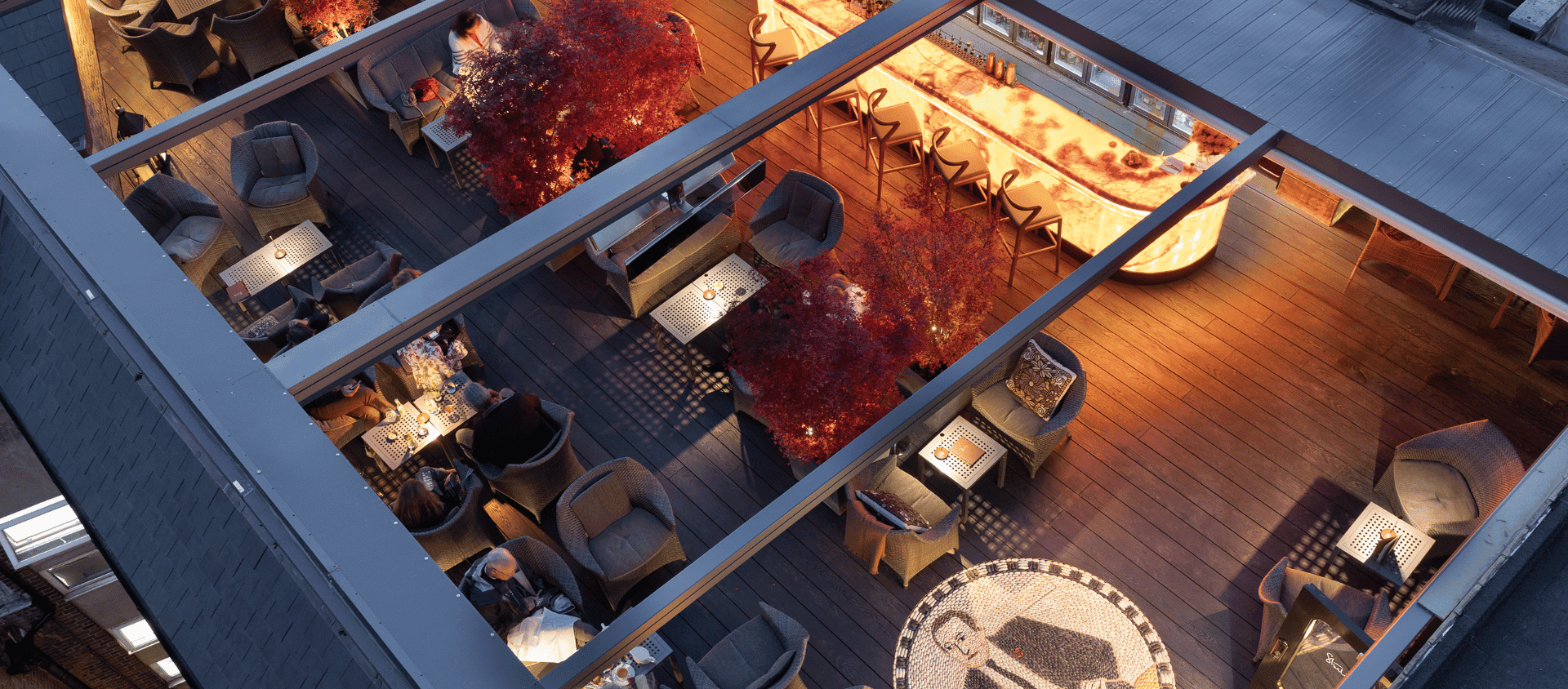 The Chesterfield Mayfair rooftop terrace at dusk.