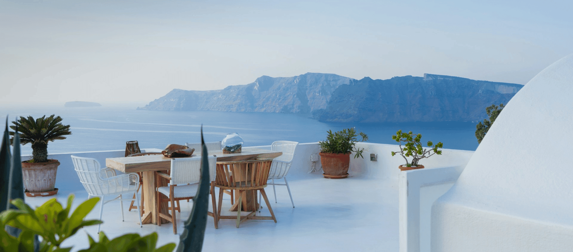 Cliffside terrace overlooking the Santorini caldera and Aegean Sea