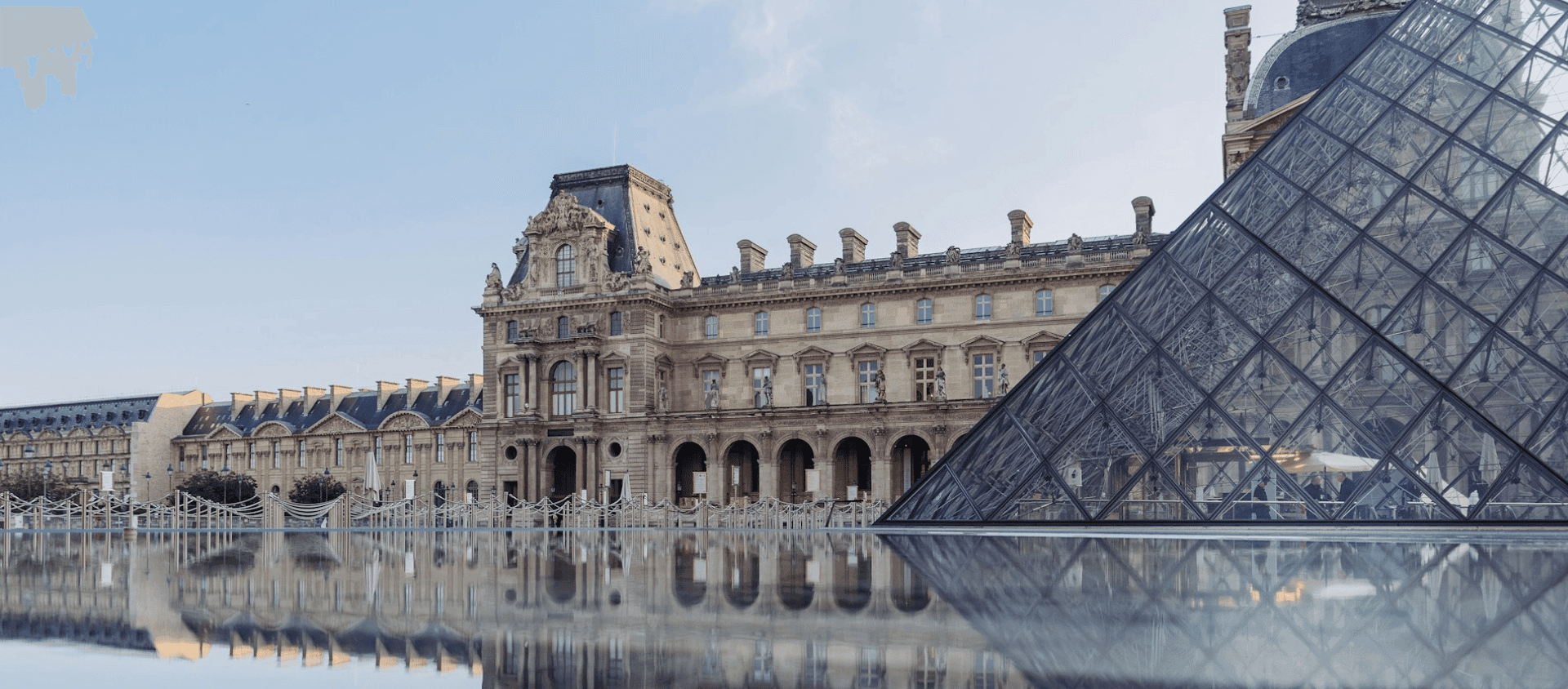 Louvre Museum and glass pyramid courtyard in Paris.