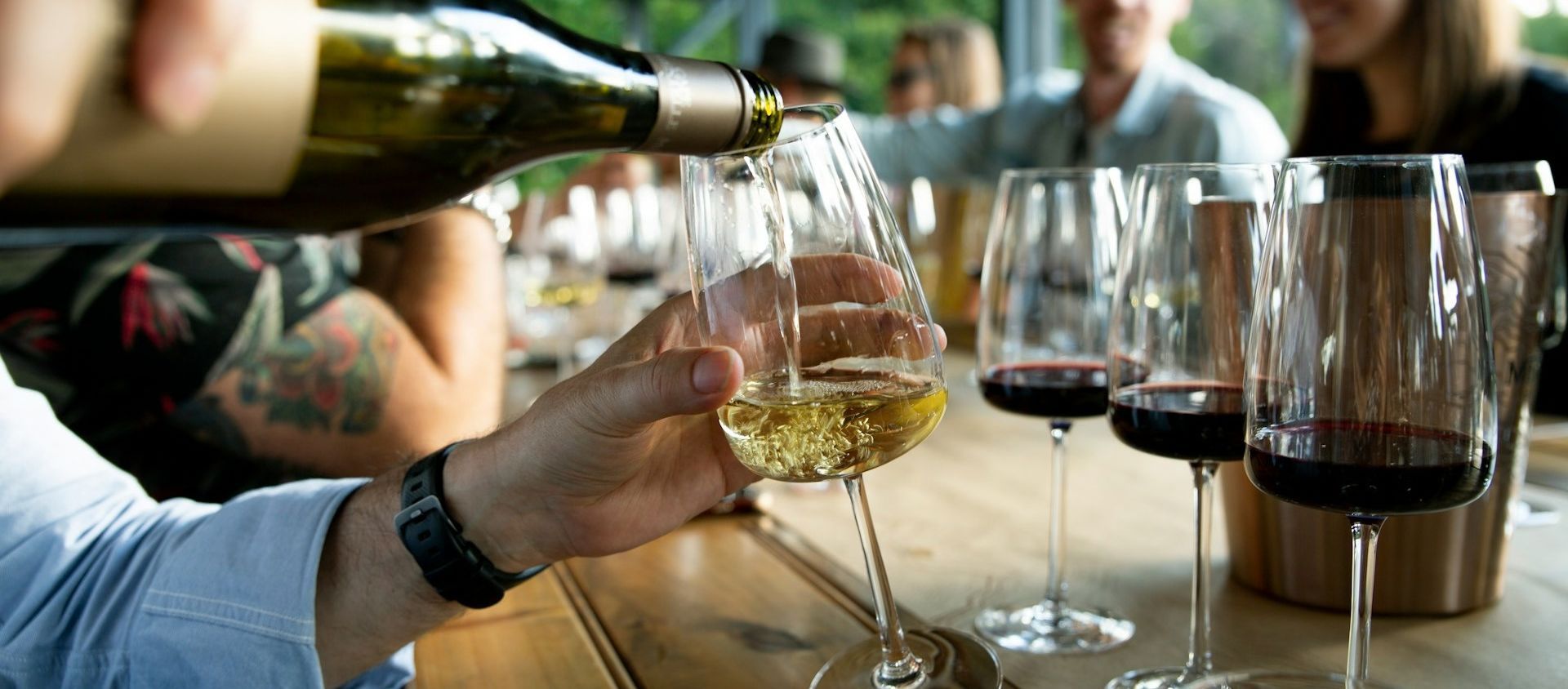A group of friends together with wine glasses at a private wine tasting.