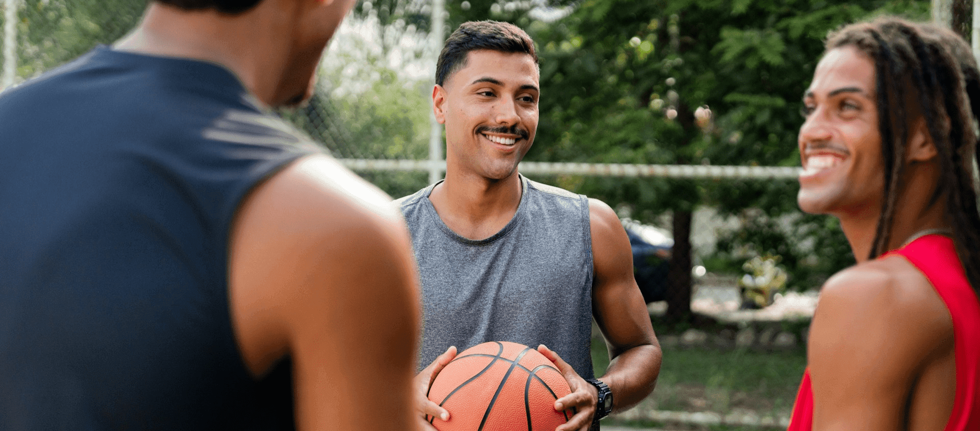 Guys playing basketball together