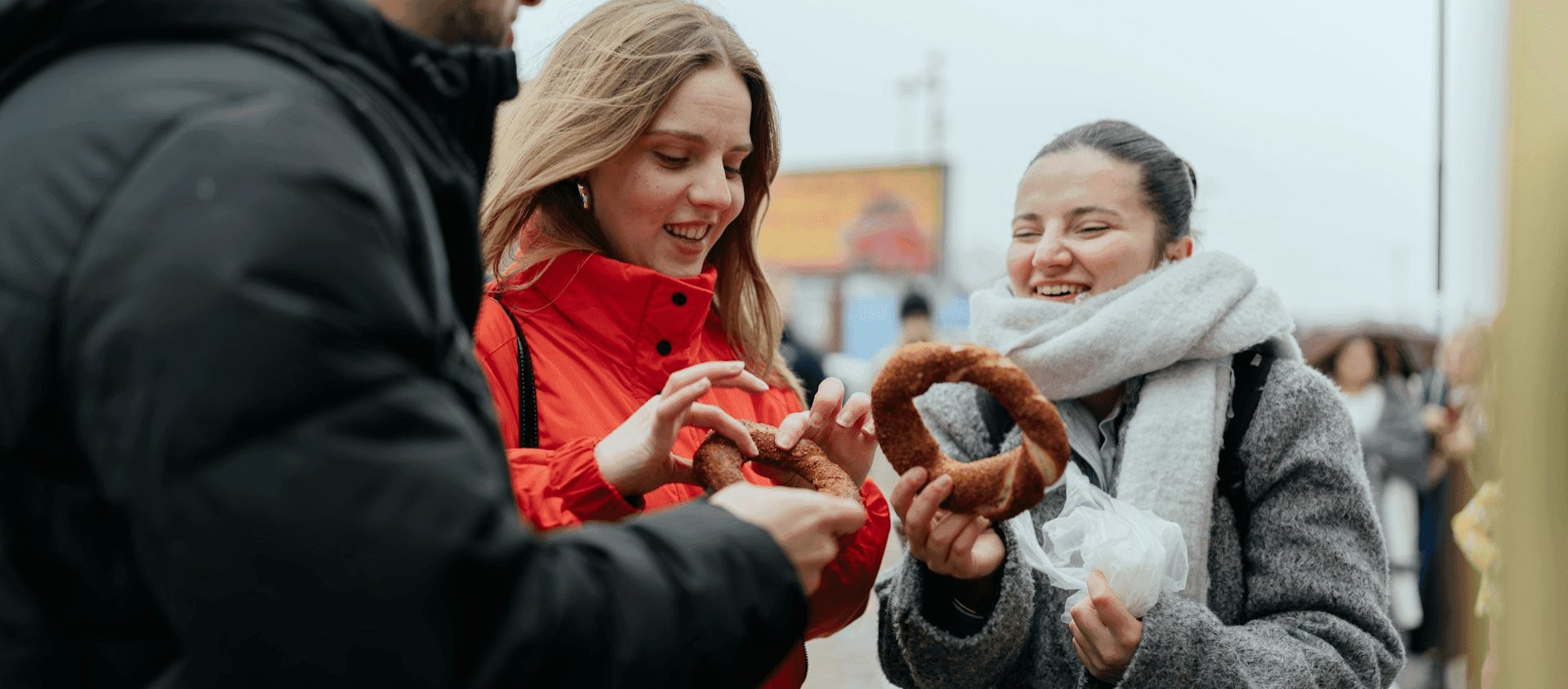 Group of travelers splitting a pretzel