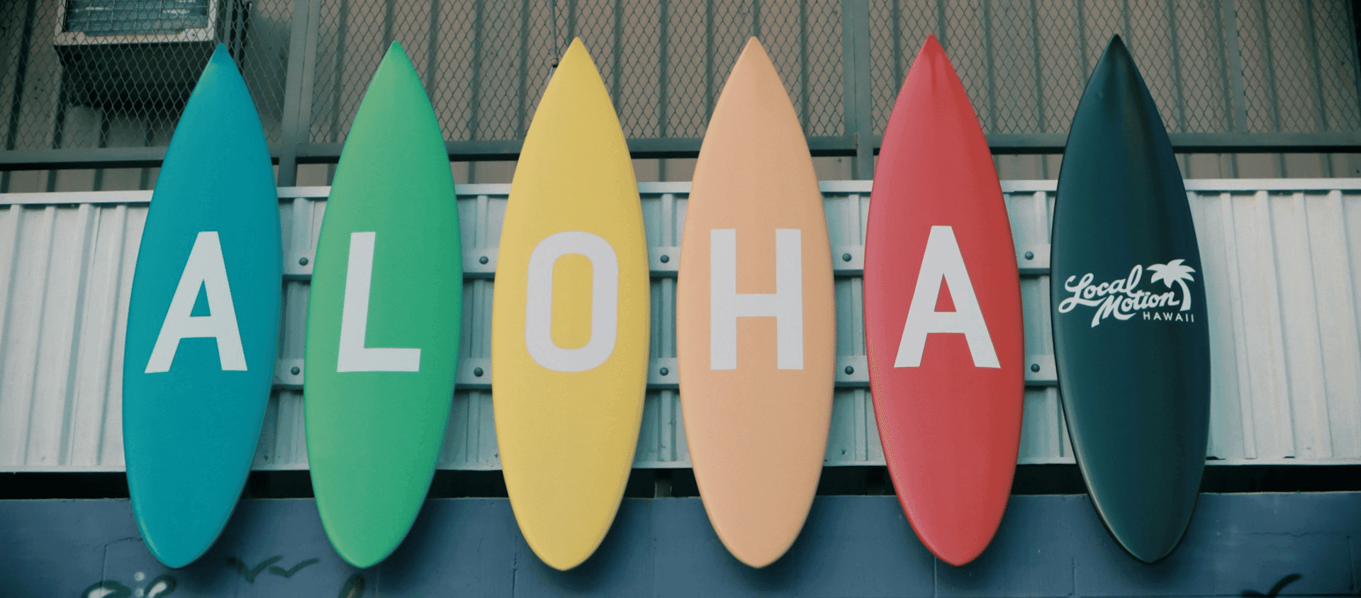 Yellow and blue surf boards that spell, "Aloha".