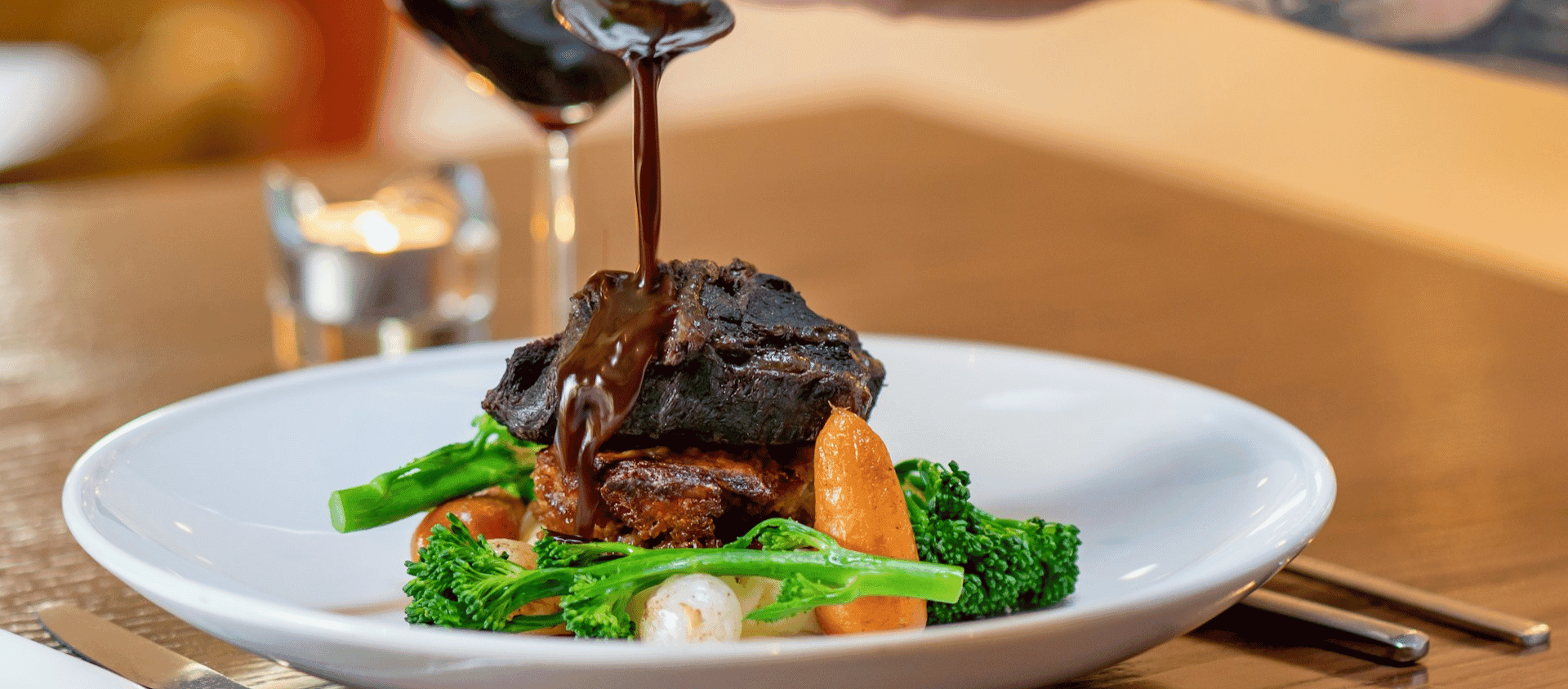 Red wine braised short ribs plated with vegetables.