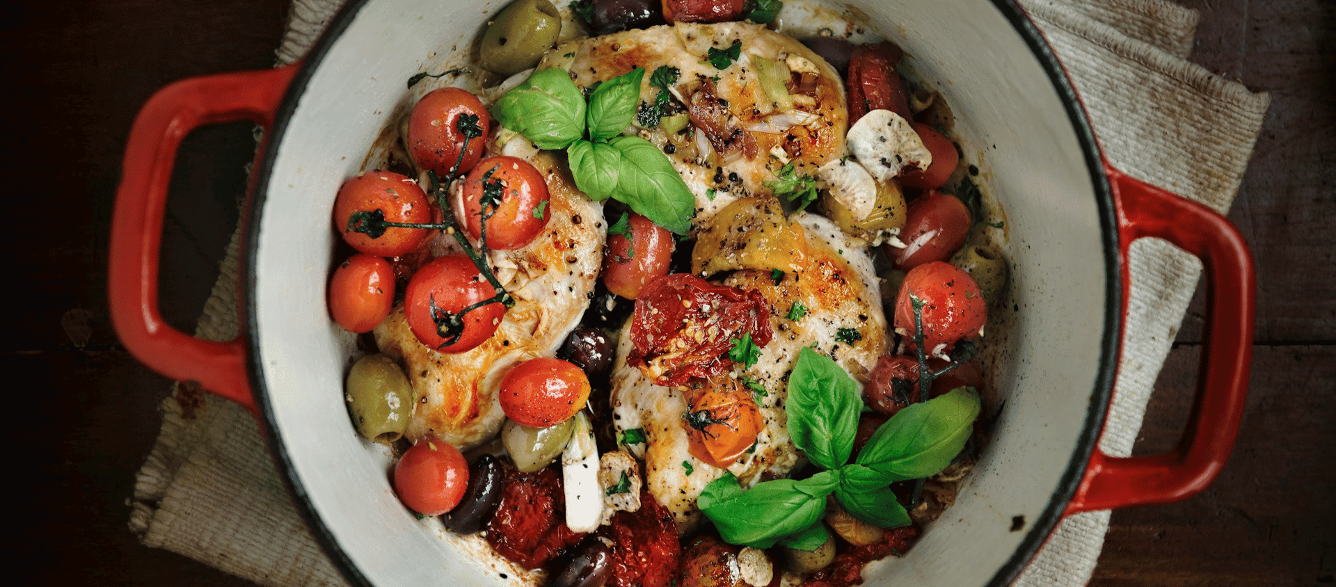 Stuffed chicken breast with vegetables in a baking dish.