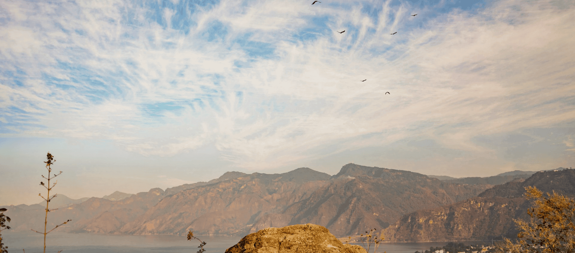 Birds flying over a body of water in Atitlán, Guatemala