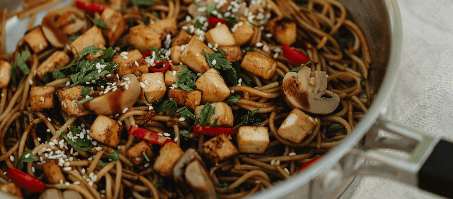 Pad kee mao noodles with vegetables and herbs.