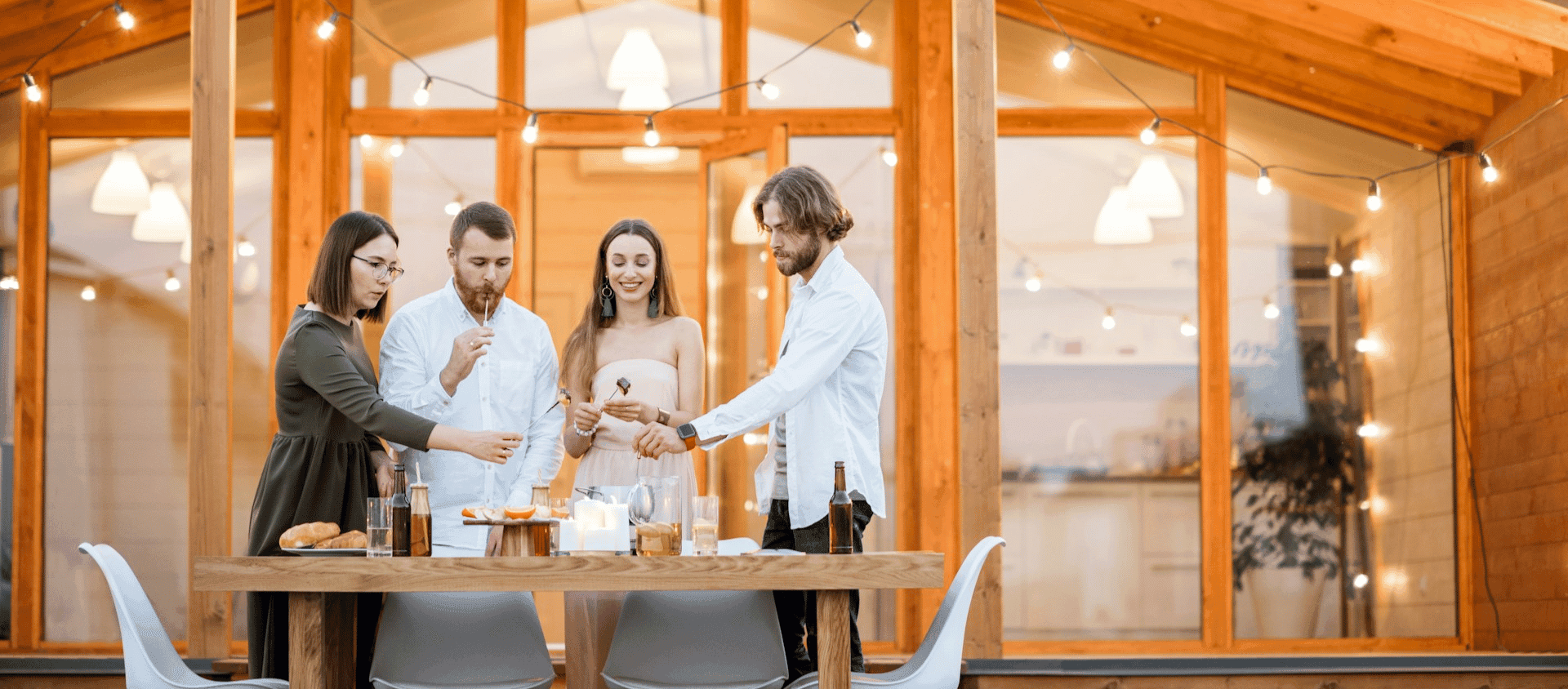 Group of people gathered around a table having a fondue party.