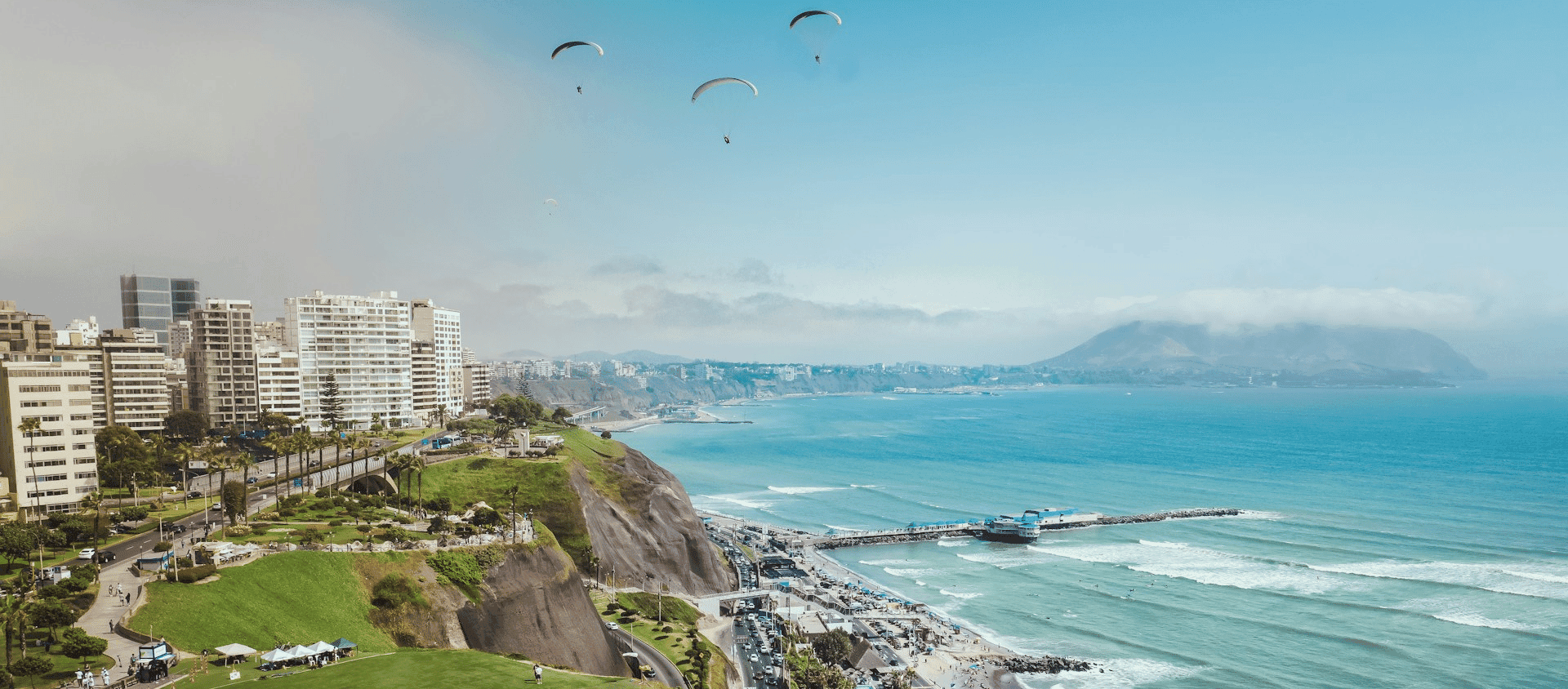 Aerial view of the Miraflores coastline in Lima with paragliders over the Pacific