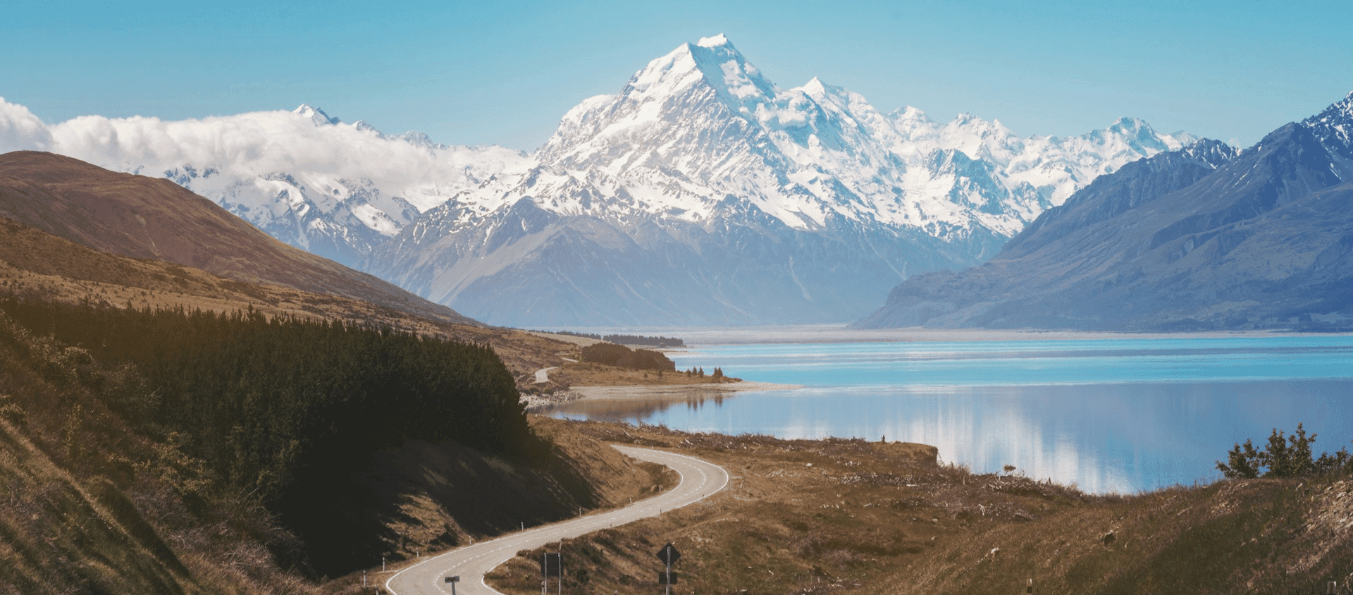 Winding road leading to Aoraki Mount Cook and Lake Pukaki on a New Zealand South Island road trip