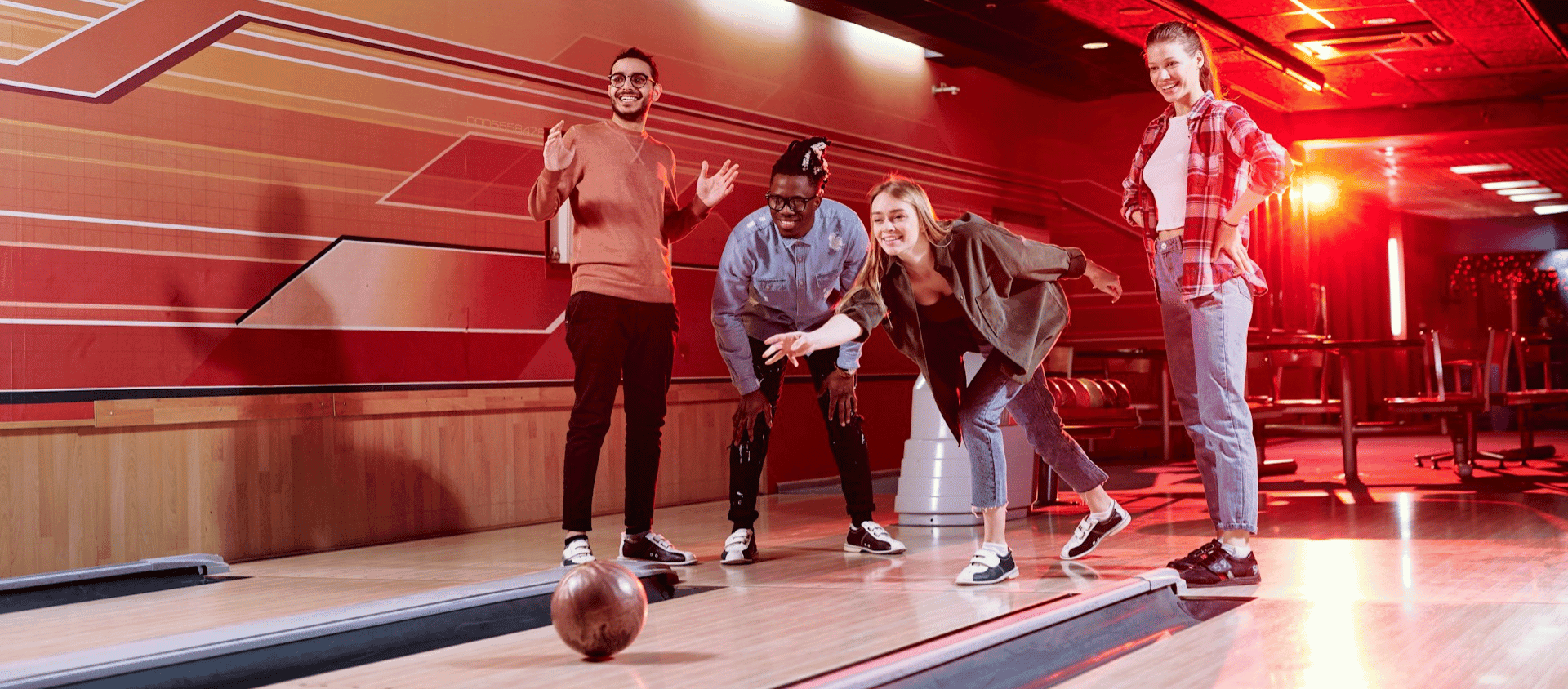 Group of friends celebrating together at a bowling alley.