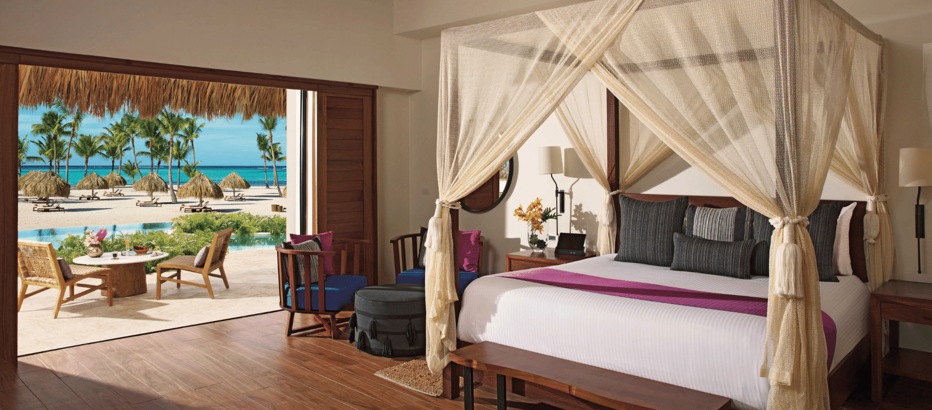 Ocean view suite with canopy bed and balcony overlooking the beach at Secrets Cap Cana.