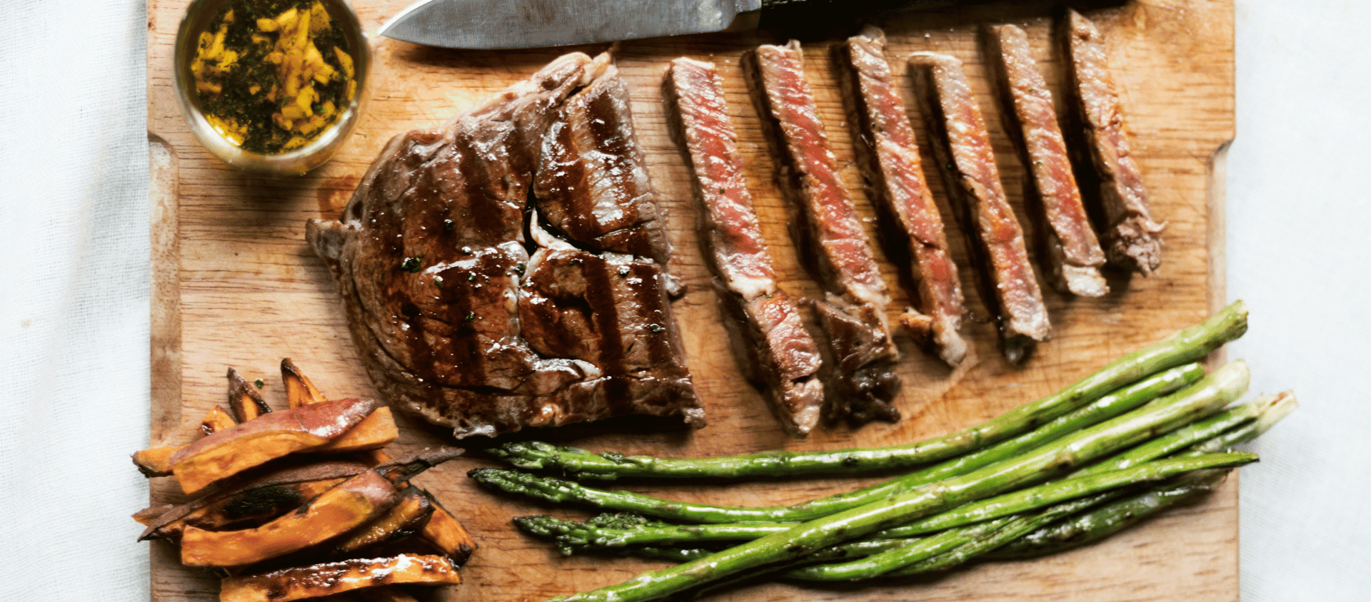 Veal Marsala with sauce and asparagus.