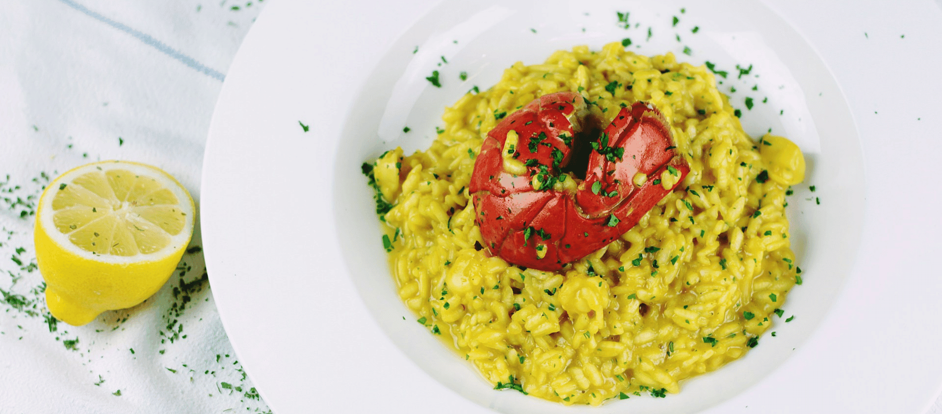 Lobster risotto served in a bowl with herbs.