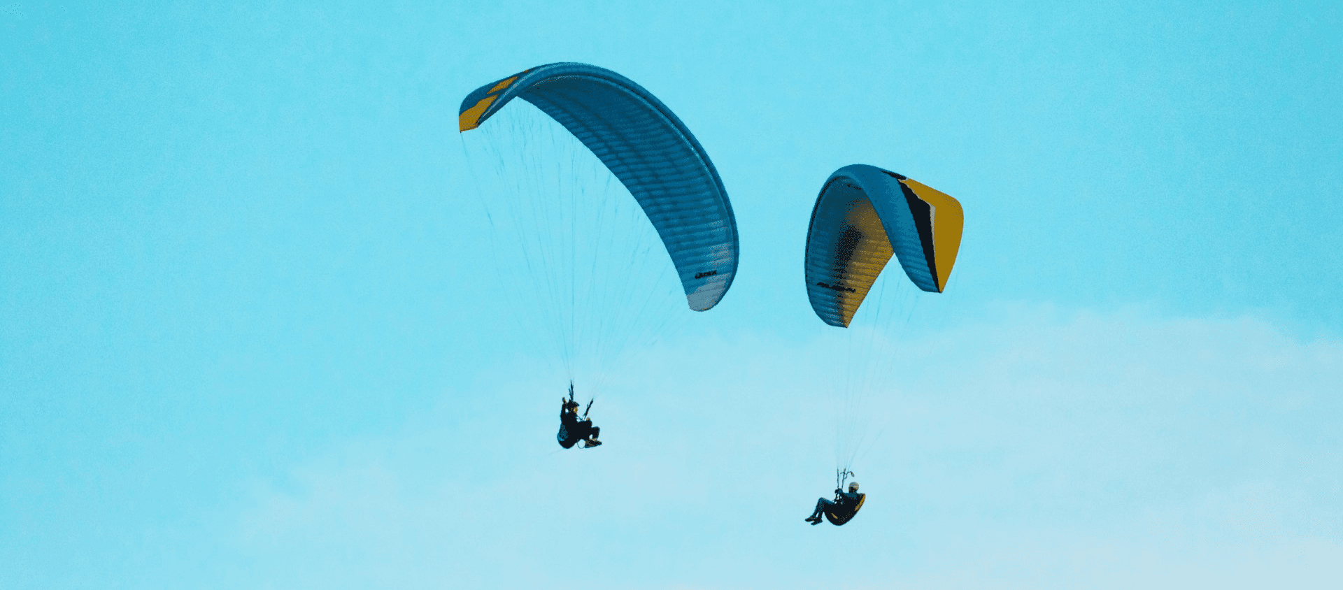 Two people paragliding in the air