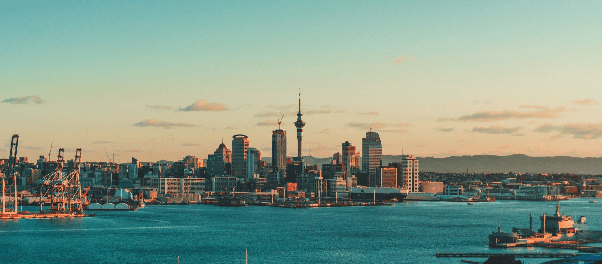 Auckland city skyline at sunset viewed from the harbor New Zealand North Island