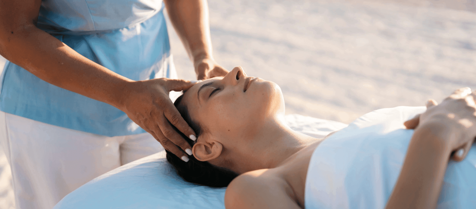 Woman receiving a relaxing beachside spa massage at Secrets Cap Cana.