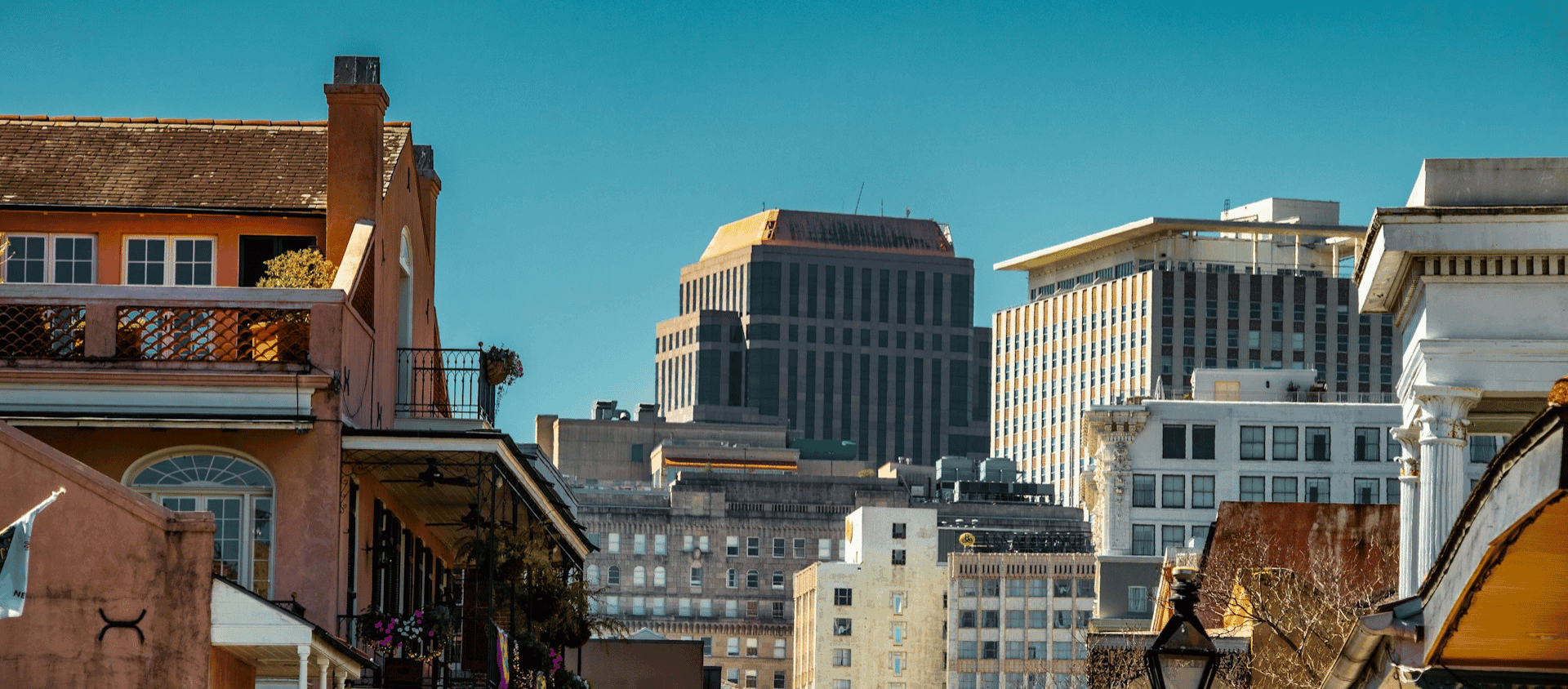 A New Orleans city street lined with tall buildings during the daytime.