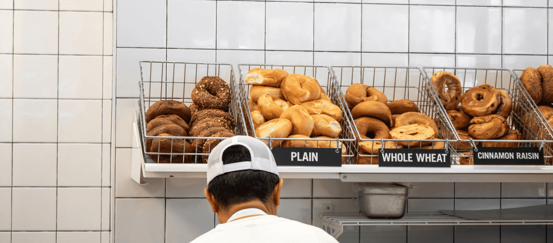 Fresh bagels displayed in baskets inside a New York City deli.