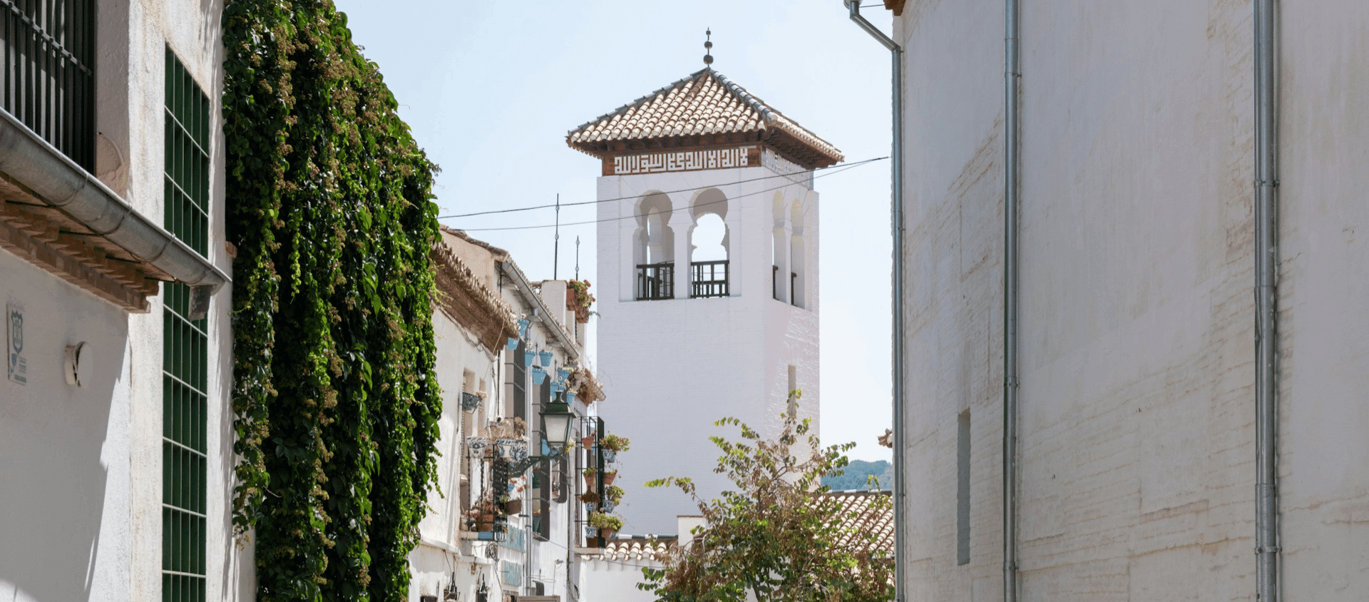 Whitewashed Andalusian street with traditional tower