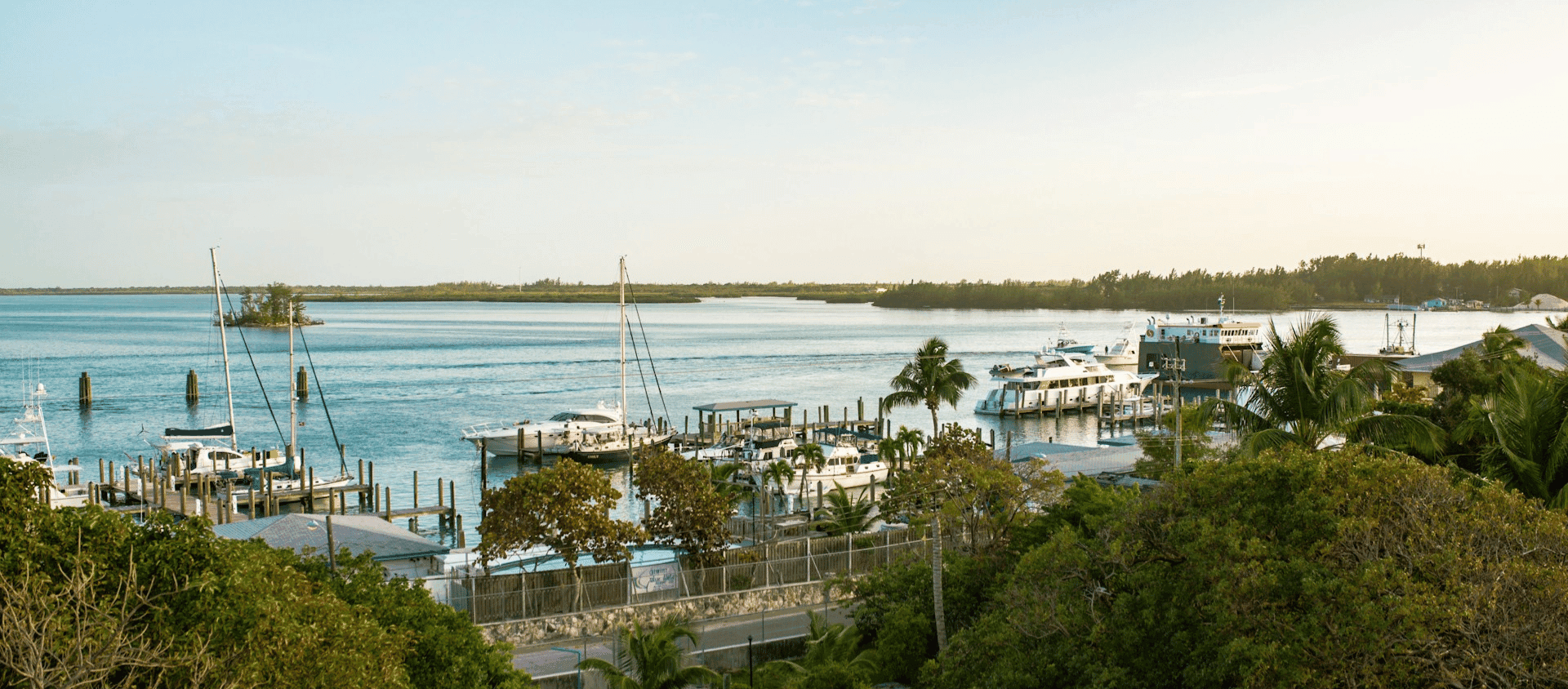 Boats docked at a marina in the Bahamas at sunset
