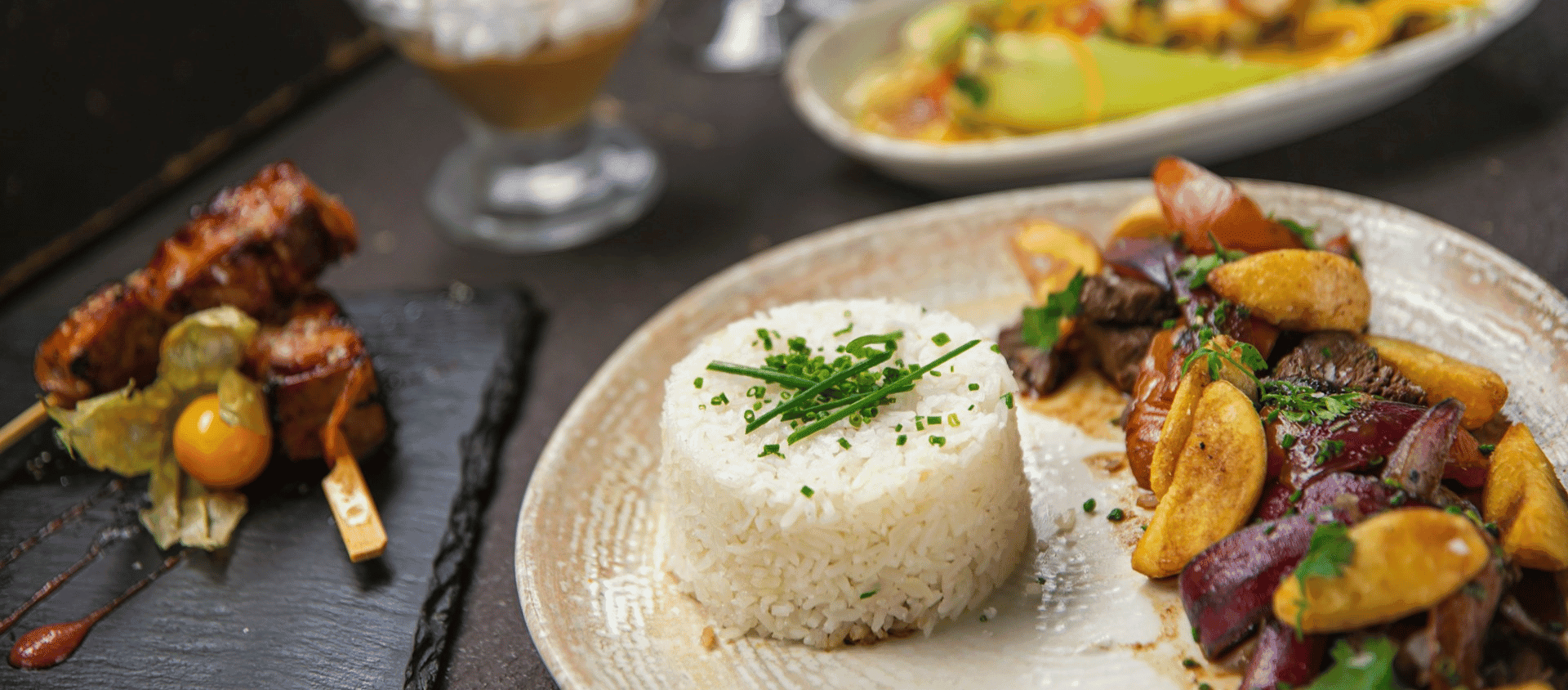 Plate of traditional Peruvian cuisine including lomo saltado with rice.