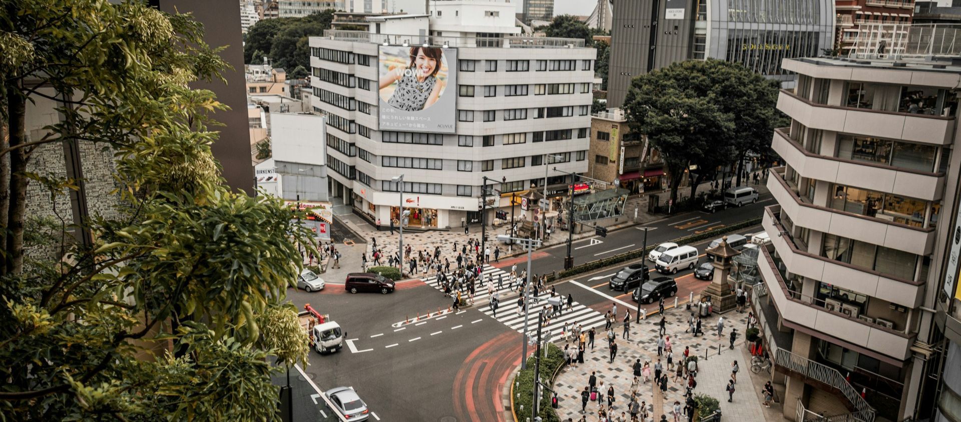 Aerial view of a busy city street lined with buildings.