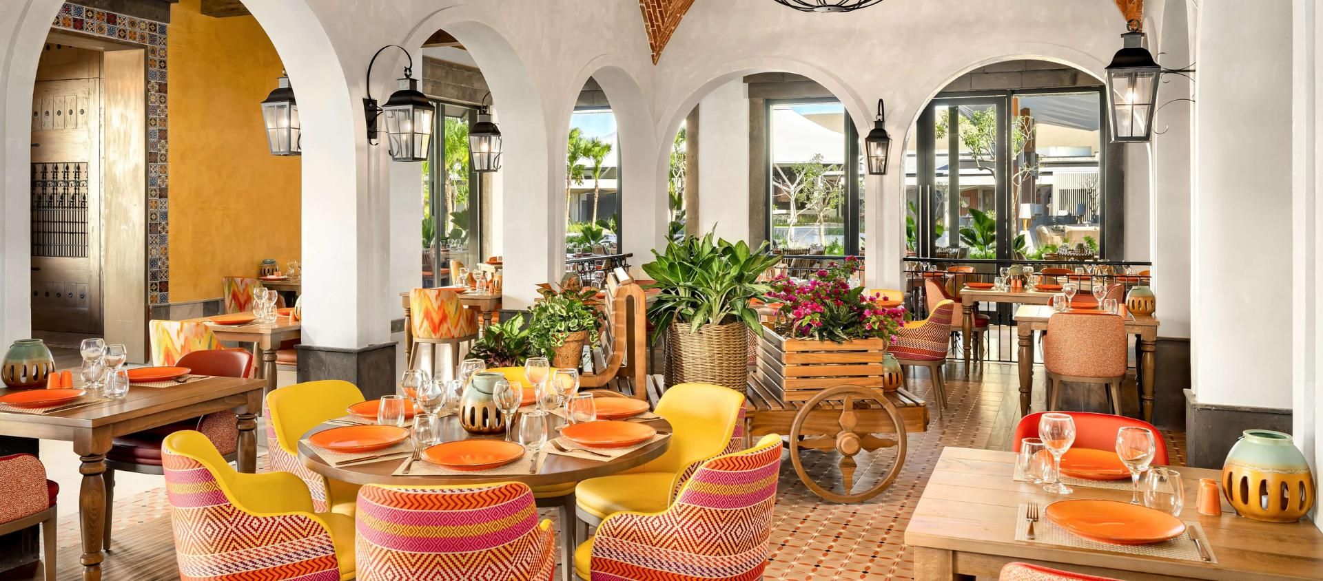 Restaurant dining room with vibrant place settings at Secrets Tides Punta Cana.