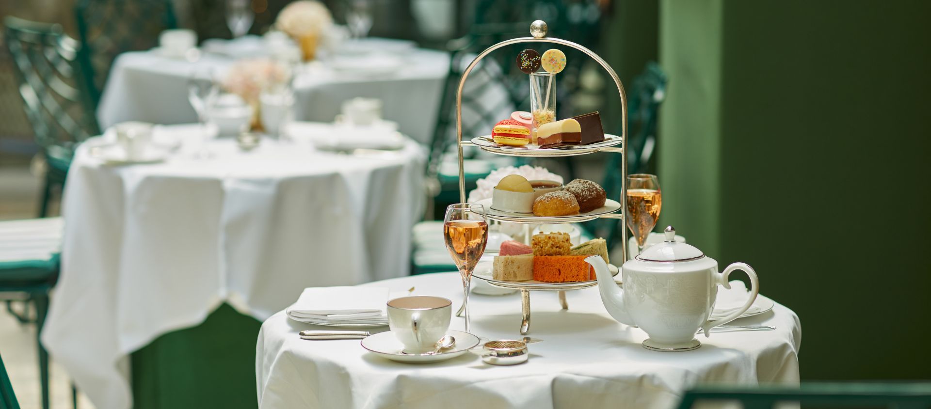 High tea table set up with champagne and dessert tower.