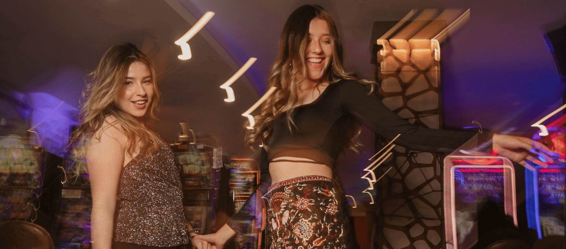 Two women dancing and laughing together inside a Las Vegas nightclub.