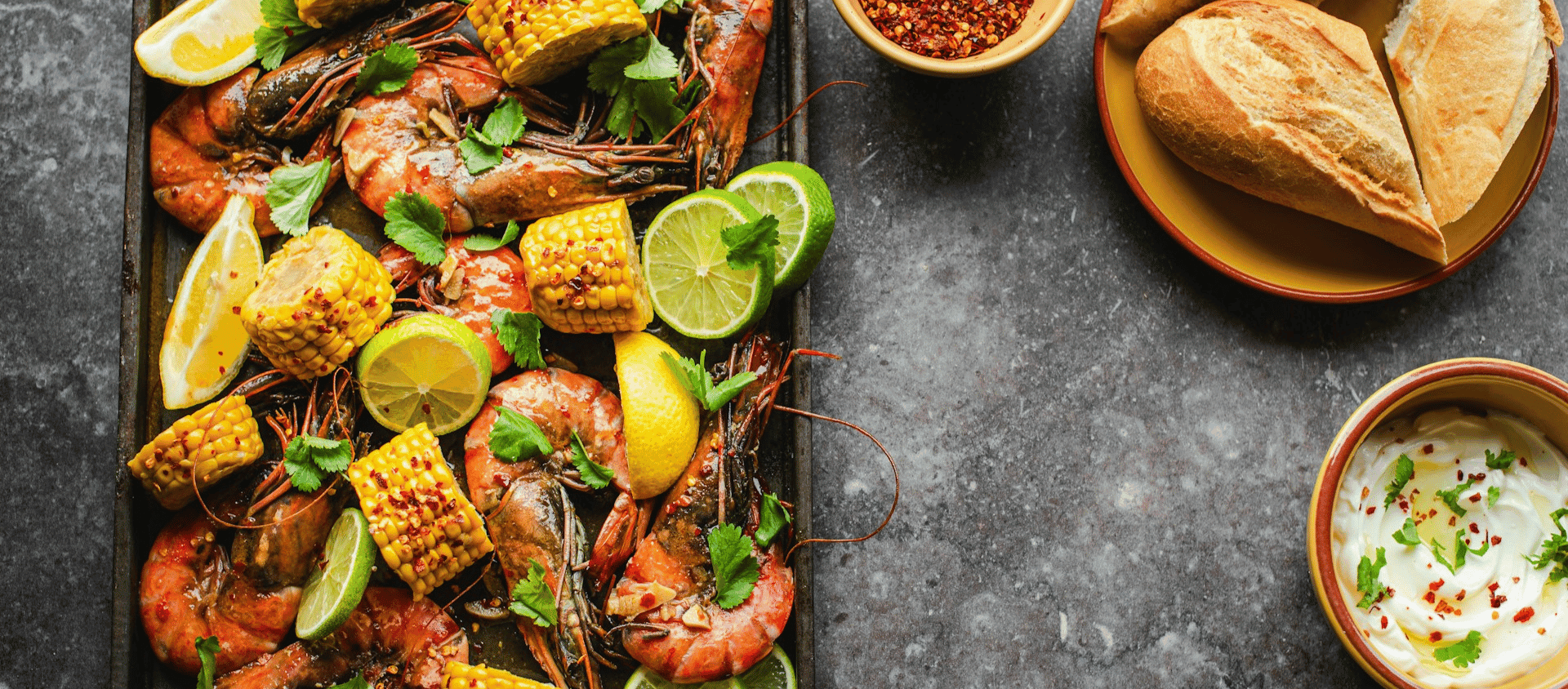 Sheet pan shrimp boil with corn, sausage, and potatoes.