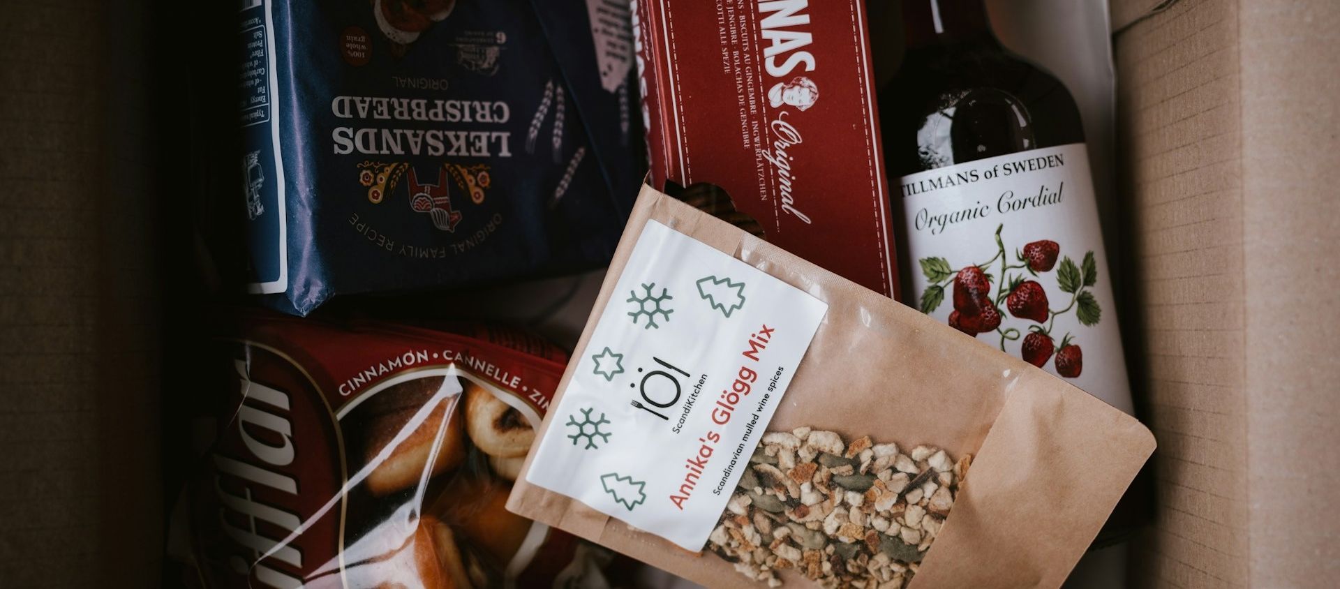 Assorted Scandinavian snacks, drink mixes, cookies, and cordial packed in a gift box.