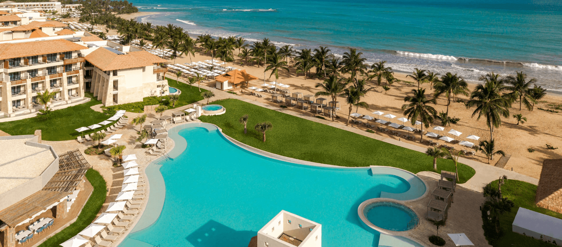 Aerial view of Dreams Playa Esmeralda resort pool along the Miches coastline.