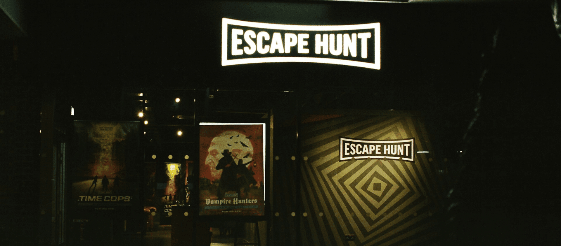 The entrance of an escape room venue with illuminated “Escape Hunt” signage.