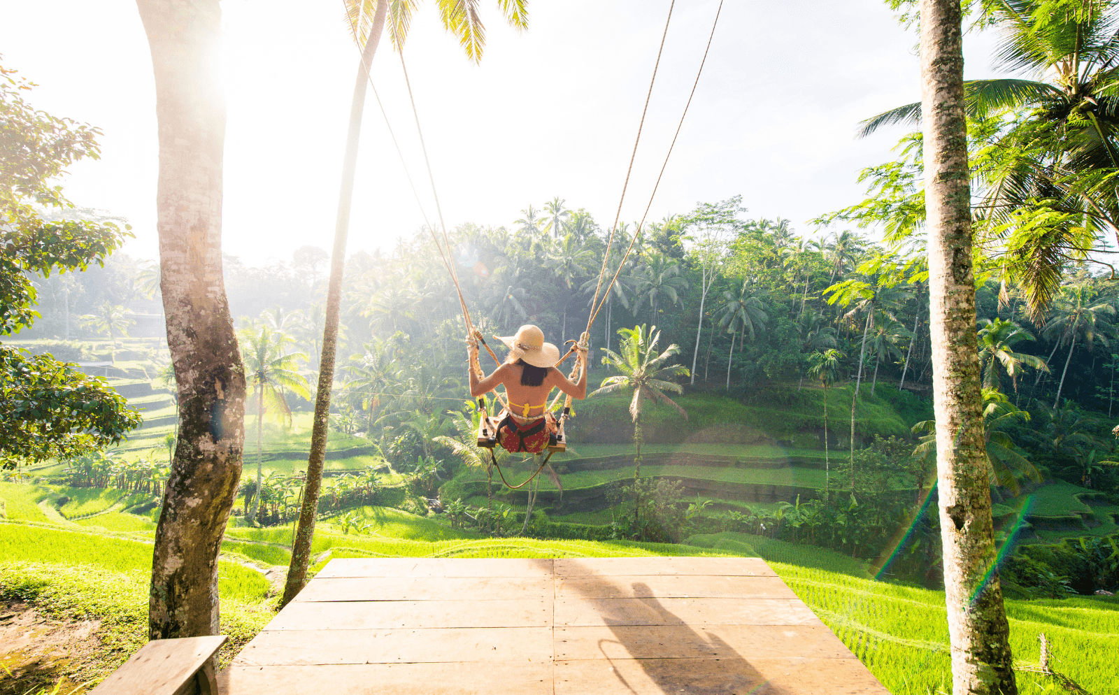A woman on a jungle swing in Bali, one of the top destination birthday party ideas abroad.