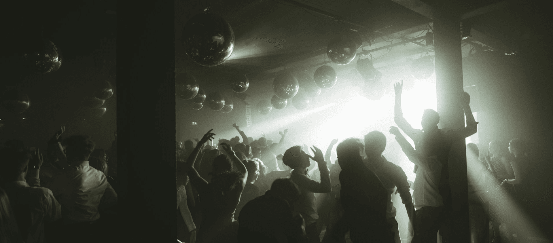 Prom happening with disco balls on the ceiling.