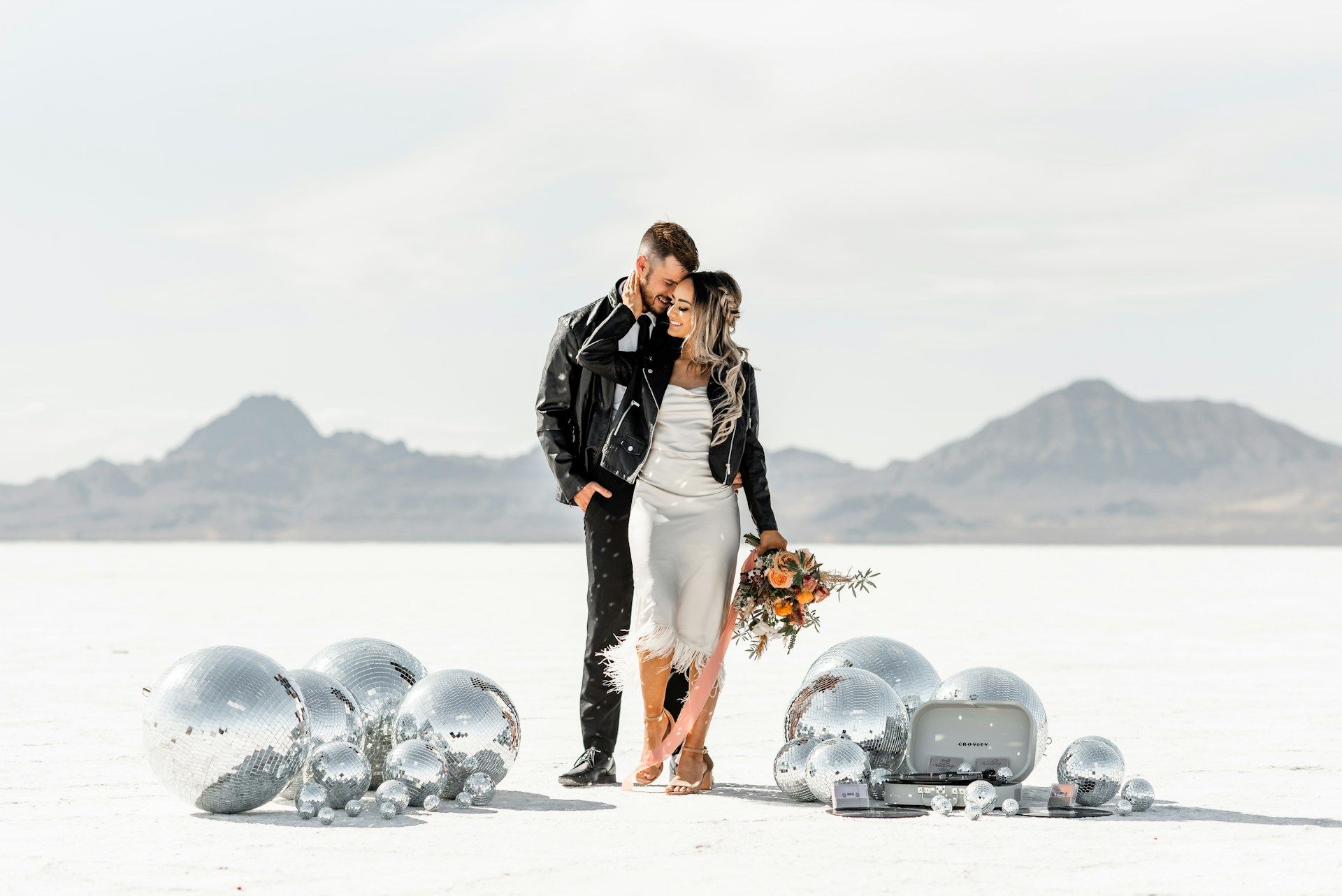 A couple standing in the middle of the desert