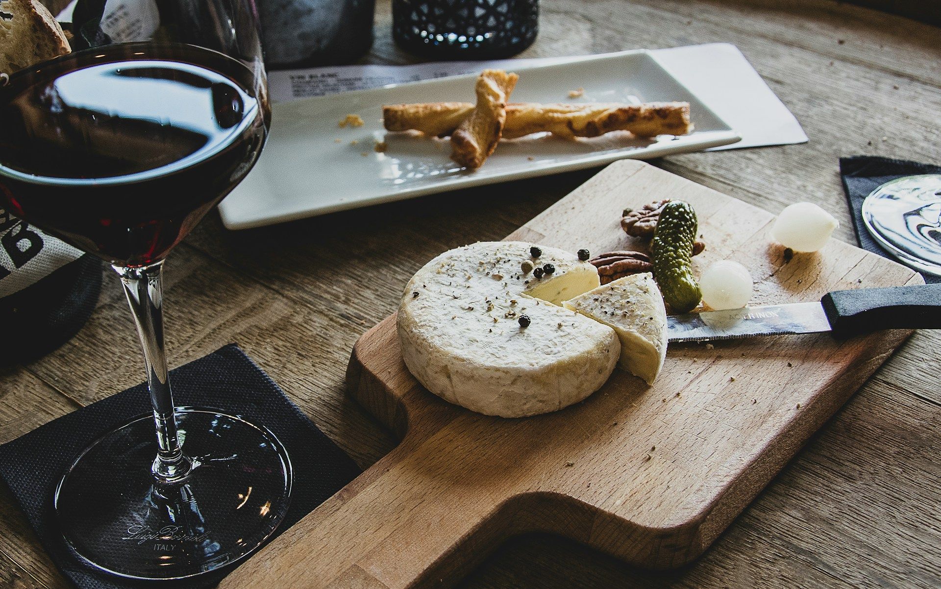 Cheese board and wine set on a table during a shared meal gathering
