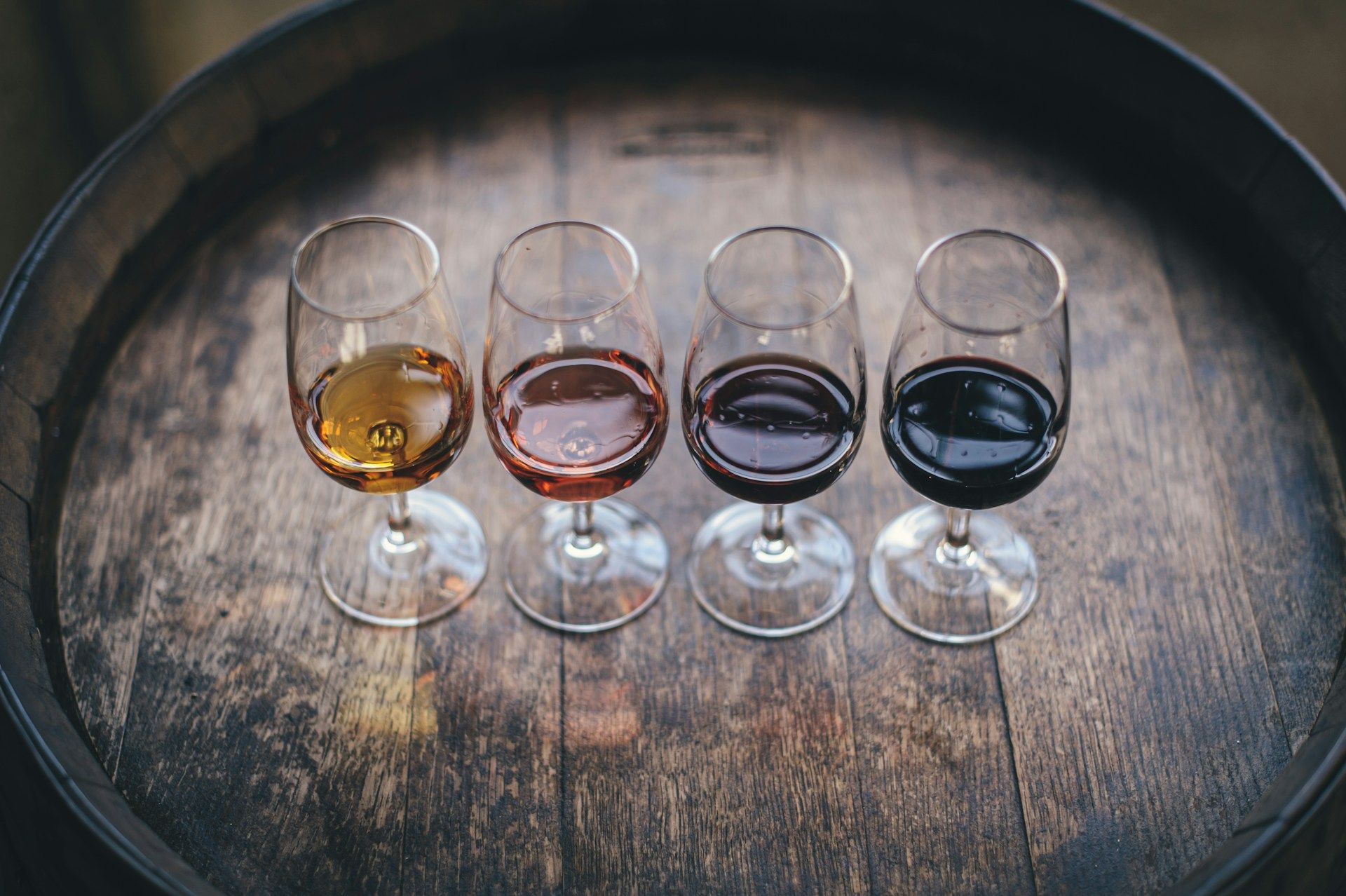 four wine tastings on a wooden barrel