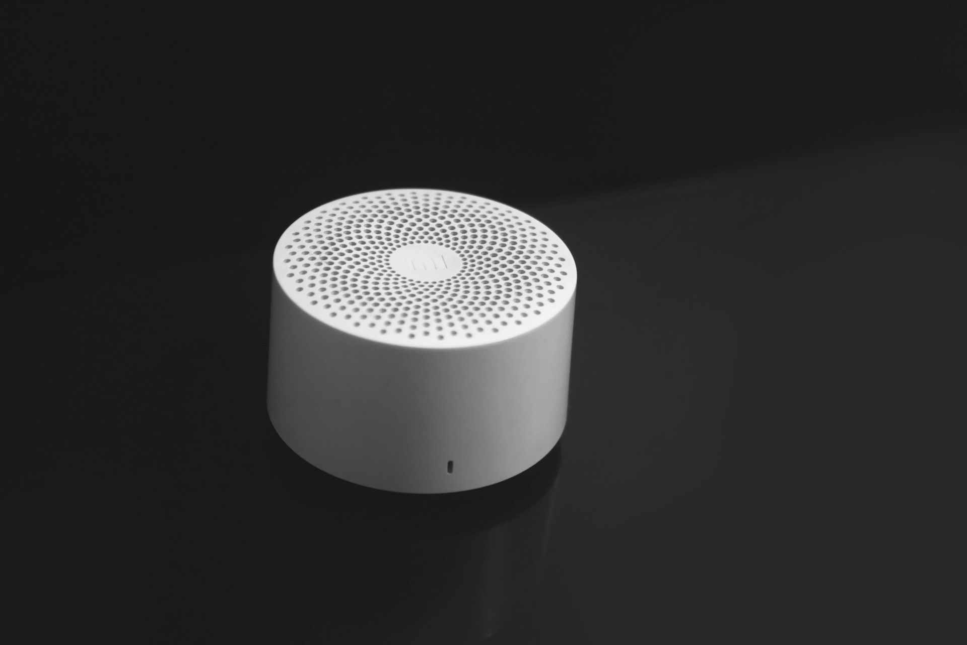 Small white portable sound machine on a dark surface.